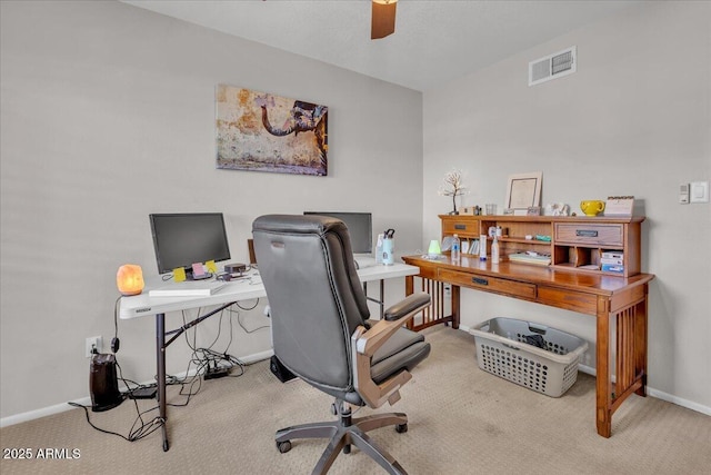 carpeted office space with visible vents, ceiling fan, and baseboards