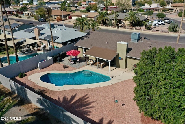 view of pool with a fenced in pool, a residential view, a patio area, and a fenced backyard