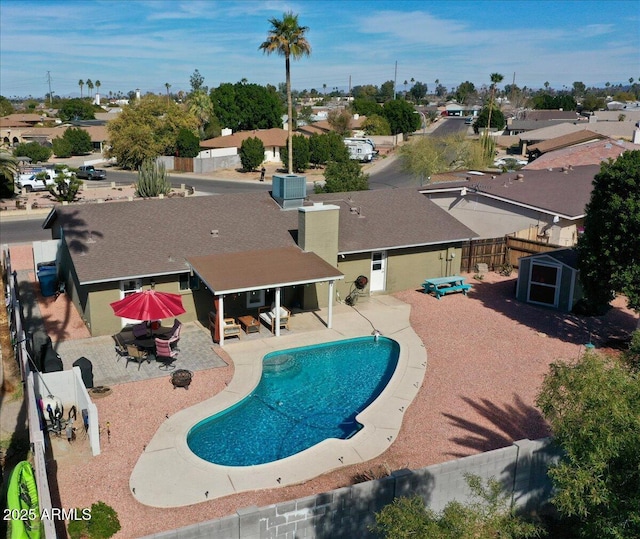 view of swimming pool featuring outdoor dining space, a fenced backyard, a fenced in pool, and a patio