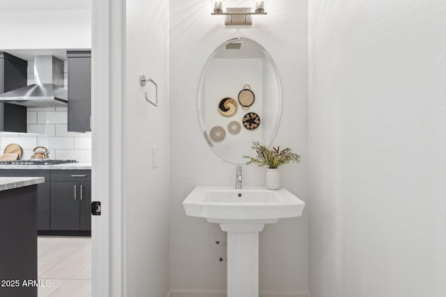 bathroom with tile patterned flooring and tasteful backsplash