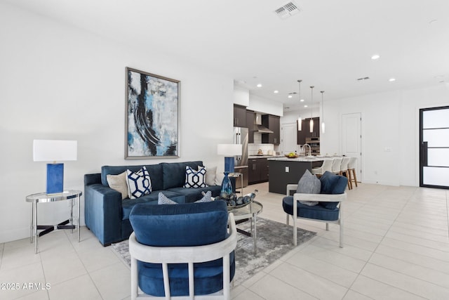 living area featuring visible vents, recessed lighting, and light tile patterned floors