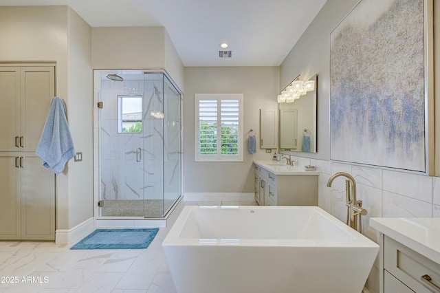 bathroom featuring plus walk in shower and vanity