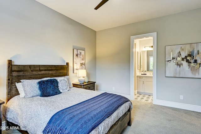 bedroom with light carpet, ceiling fan, and ensuite bath