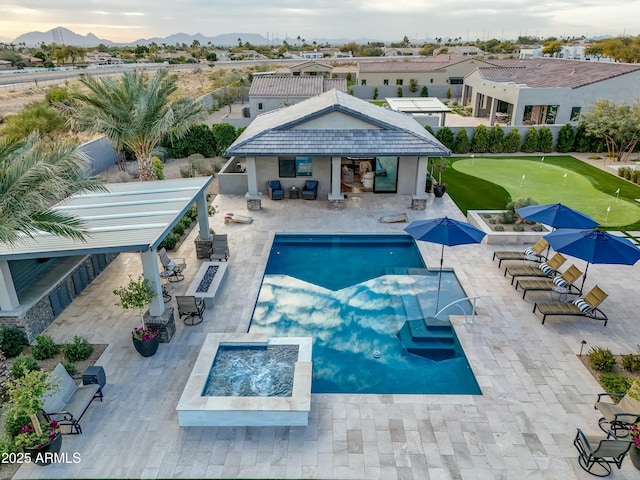 view of pool with a mountain view, a patio area, and an outdoor fire pit