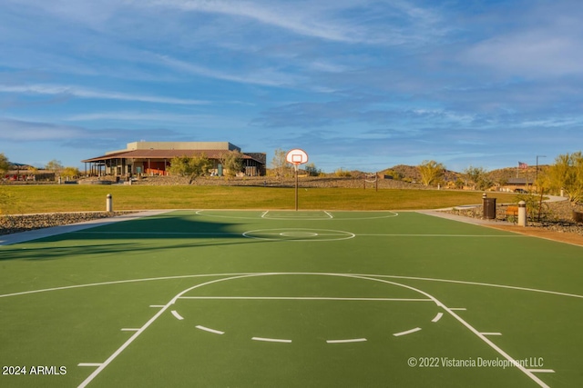 view of basketball court with a yard