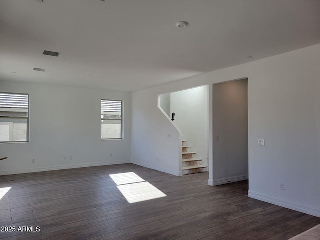 spare room featuring dark hardwood / wood-style flooring