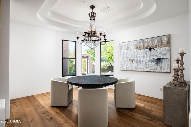 7025 E Ashler Hills Dr, Scottsdale, AZ 85266 - dining space with dark wood-style floors, a chandelier, and a tray ceiling