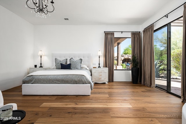 7025 E Ashler Hills Dr, Scottsdale, AZ 85266 - bedroom with access to outside, a chandelier, and light wood finished floors
