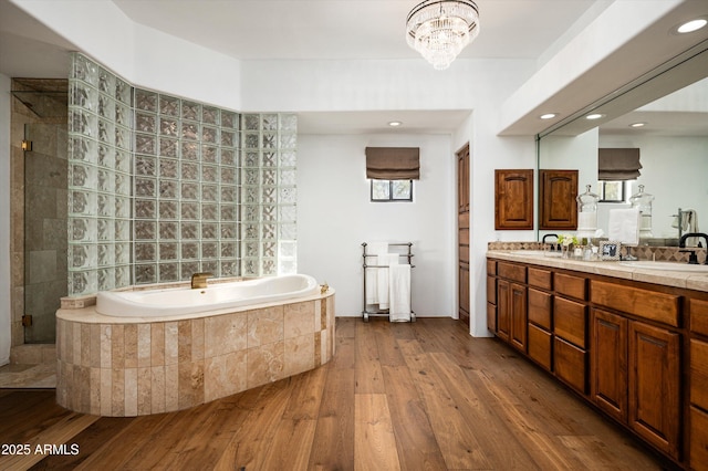 7025 E Ashler Hills Dr, Scottsdale, AZ 85266 - full bathroom with a bath, double vanity, a shower stall, wood finished floors, and recessed lighting