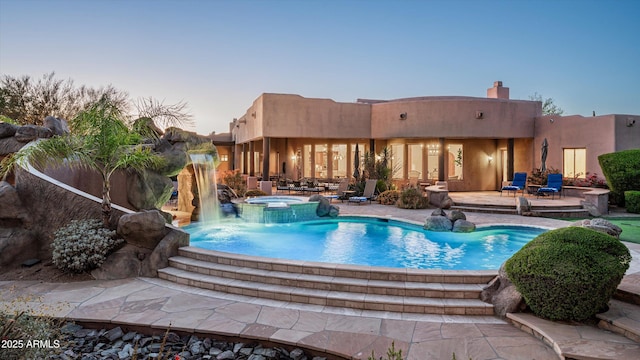 7025 E Ashler Hills Dr, Scottsdale, AZ 85266 - pool at dusk with a patio and a pool with connected hot tub