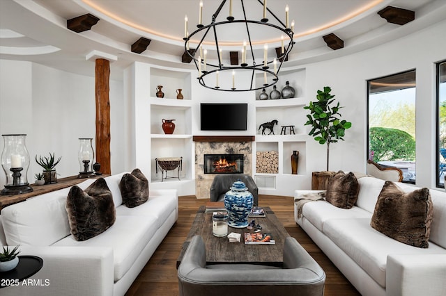 7025 E Ashler Hills Dr, Scottsdale, AZ 85266 - living room with a chandelier, built in shelves, dark wood-type flooring, and a premium fireplace