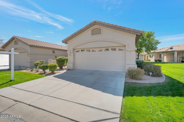 mediterranean / spanish home featuring a garage, concrete driveway, a front yard, and stucco siding