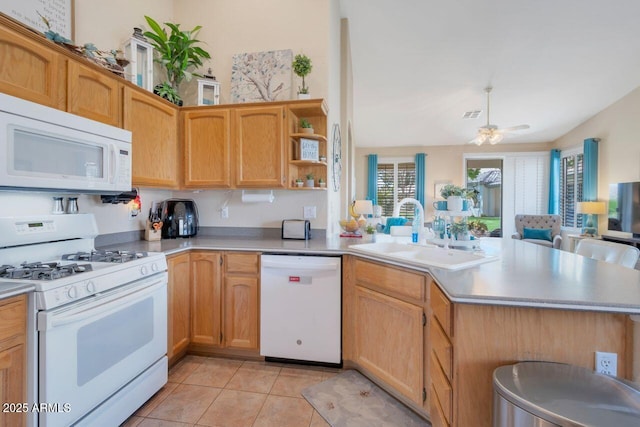 kitchen featuring light tile patterned flooring, a peninsula, white appliances, a sink, and light countertops