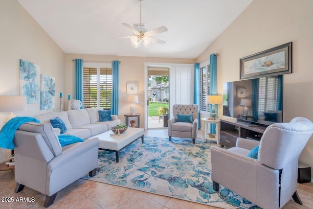 living area with light tile patterned floors, vaulted ceiling, and a ceiling fan