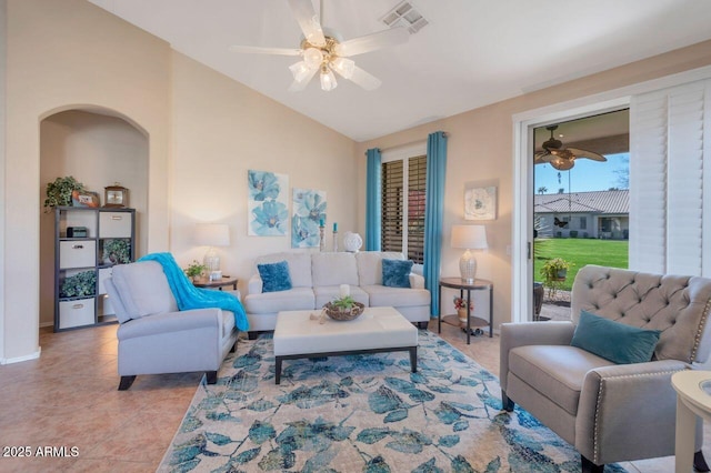 living room featuring arched walkways, light tile patterned floors, visible vents, vaulted ceiling, and ceiling fan