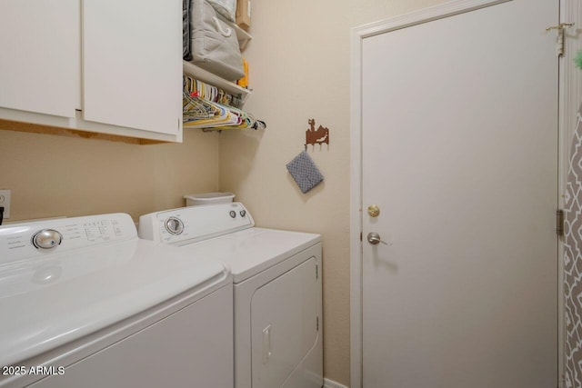 laundry room with cabinet space and washer and clothes dryer