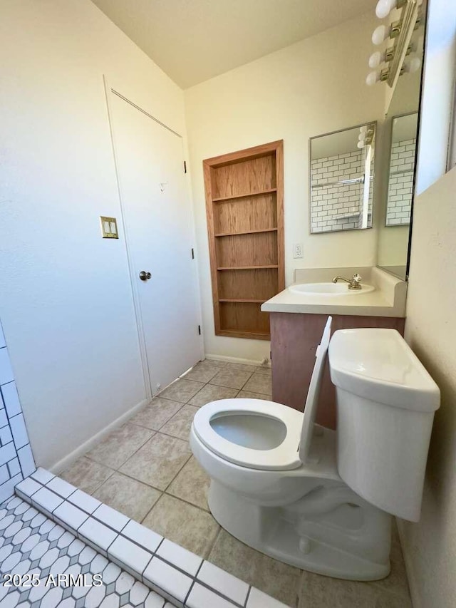 bathroom with tile patterned flooring, a sink, and toilet