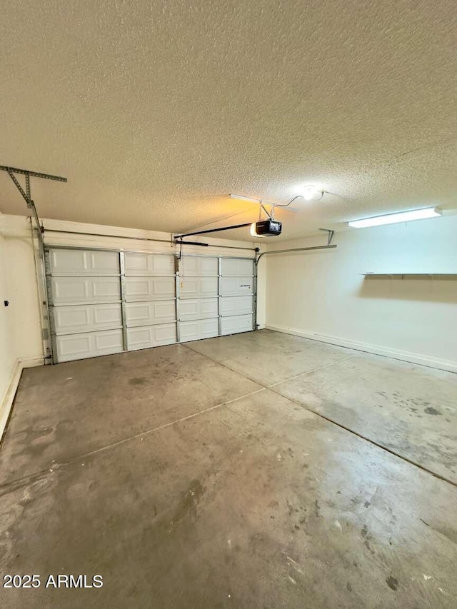 garage with baseboards and a garage door opener