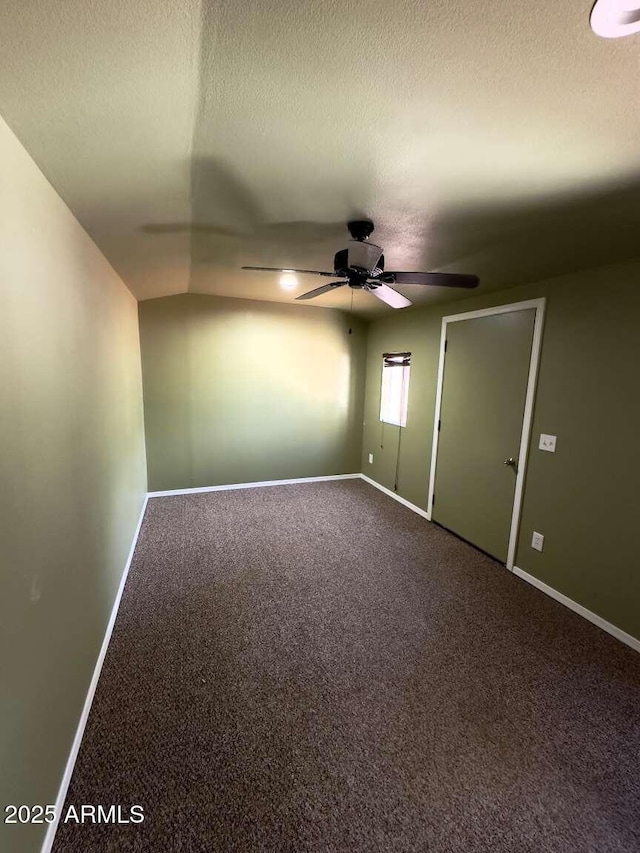 carpeted spare room with baseboards and a textured ceiling