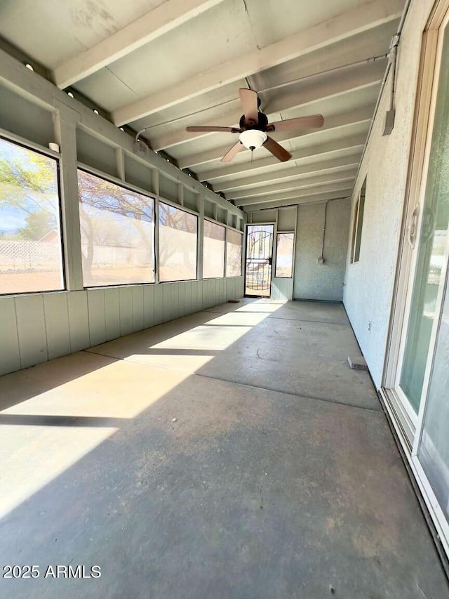 unfurnished sunroom featuring ceiling fan