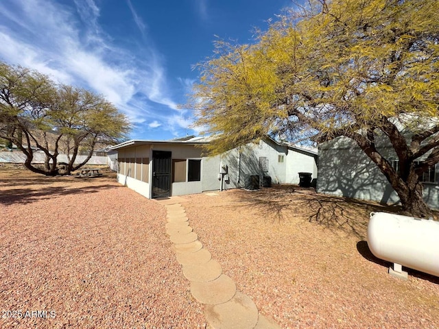 rear view of property featuring stucco siding