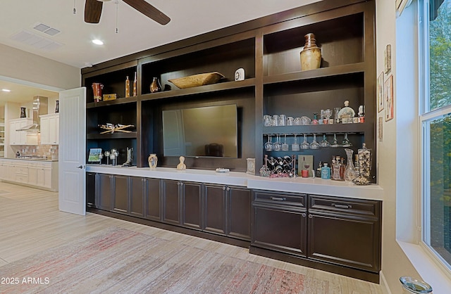 17249 E Fort Verde Rd, Rio Verde, AZ 85263 - bar area with wall chimney range hood, a ceiling fan, light wood-style floors, and decorative backsplash