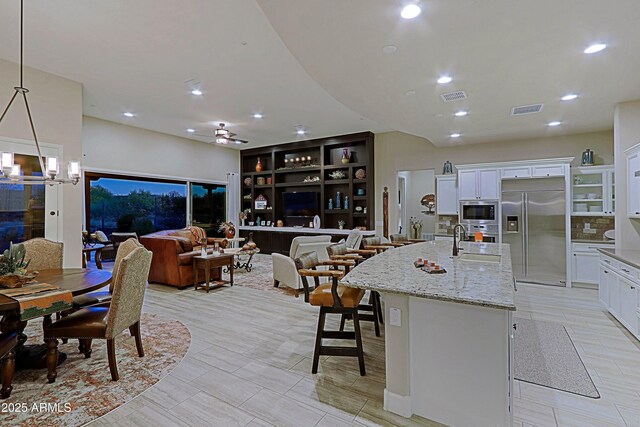 17249 E Fort Verde Rd, Rio Verde, AZ 85263 - kitchen featuring built in appliances, a chandelier, a sink, white cabinetry, and recessed lighting