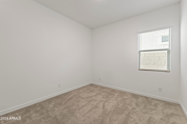 empty room with light colored carpet