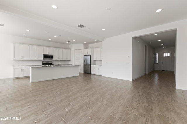 unfurnished living room featuring sink