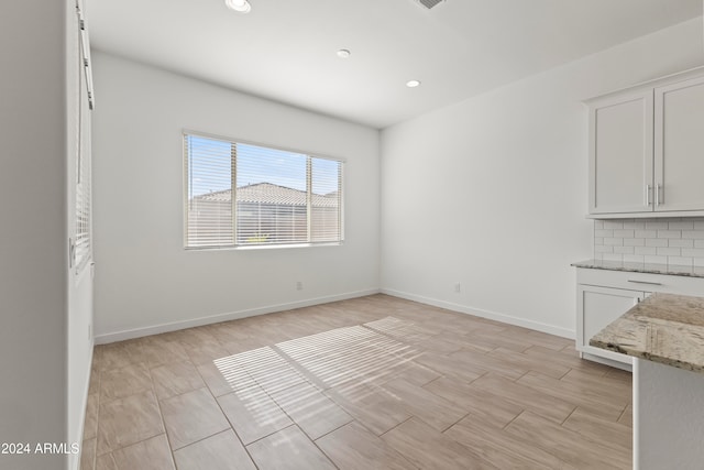 unfurnished dining area featuring light hardwood / wood-style flooring