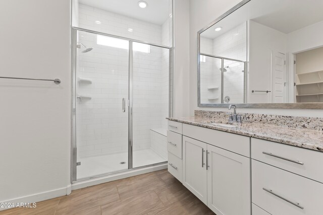 bathroom with an enclosed shower and vanity