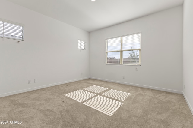 unfurnished room with light carpet