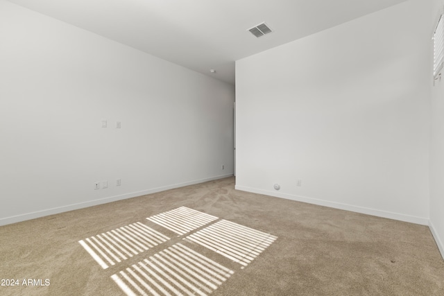 empty room featuring light colored carpet