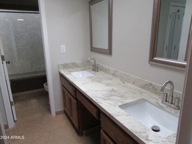 bathroom with tile patterned flooring, vanity, and toilet