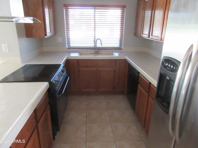 kitchen with range hood, sink, a wealth of natural light, and black appliances