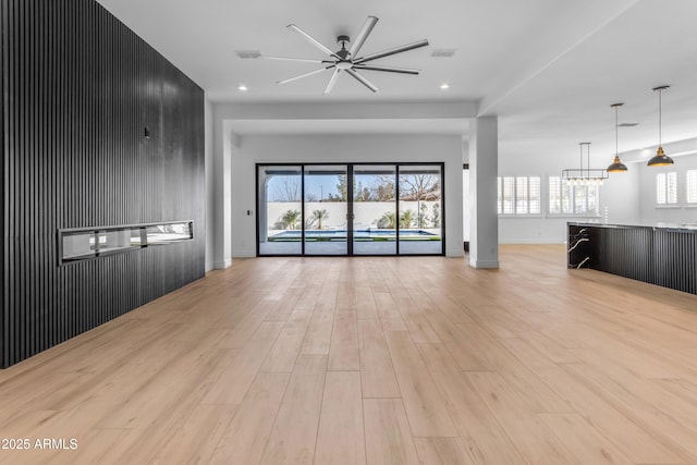 unfurnished living room featuring a ceiling fan, recessed lighting, visible vents, and light wood finished floors