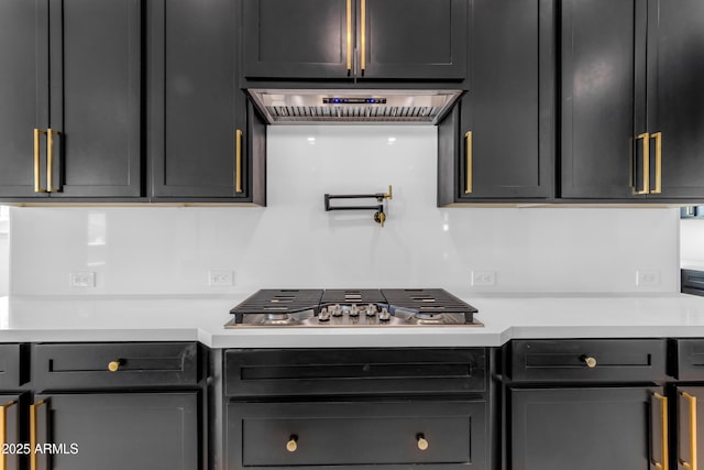 kitchen with light countertops, stainless steel gas cooktop, and custom exhaust hood