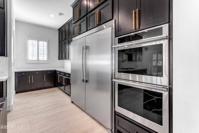 kitchen featuring visible vents, appliances with stainless steel finishes, light countertops, light wood-type flooring, and recessed lighting