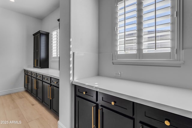 interior space featuring light wood-type flooring and baseboards