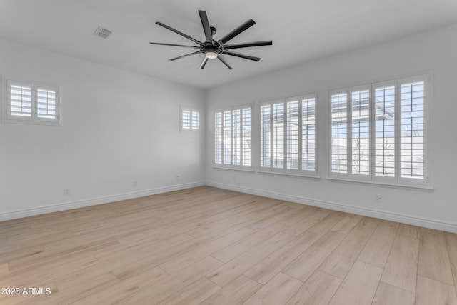 unfurnished room with baseboards, ceiling fan, visible vents, and light wood-style floors