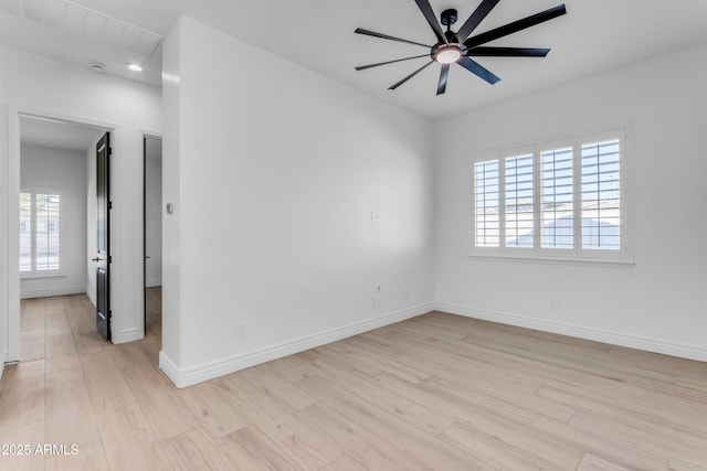 unfurnished room with light wood-type flooring, baseboards, and a ceiling fan