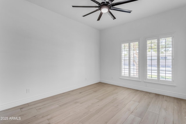 unfurnished room featuring light wood-style flooring, baseboards, and a wealth of natural light