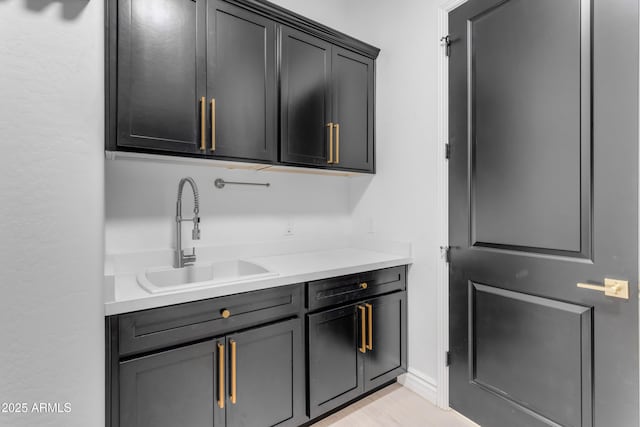 kitchen featuring light countertops and a sink