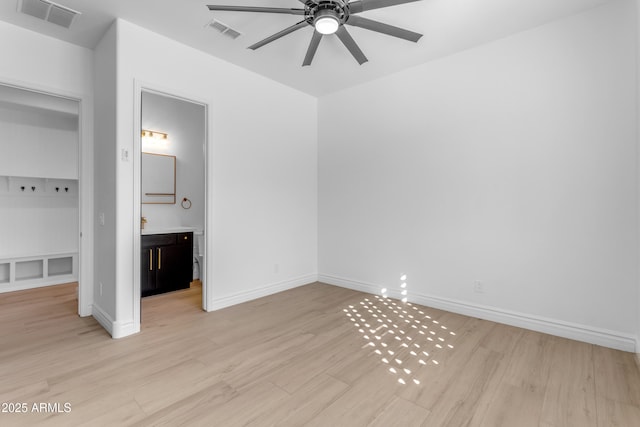 unfurnished bedroom featuring light wood-type flooring, baseboards, and visible vents