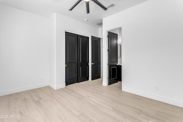 unfurnished bedroom with a closet, visible vents, ceiling fan, light wood-type flooring, and baseboards