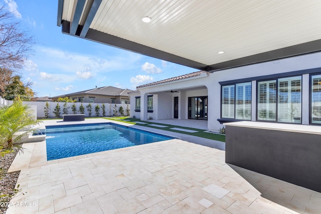 view of pool featuring a ceiling fan, a fenced in pool, a fenced backyard, and a patio