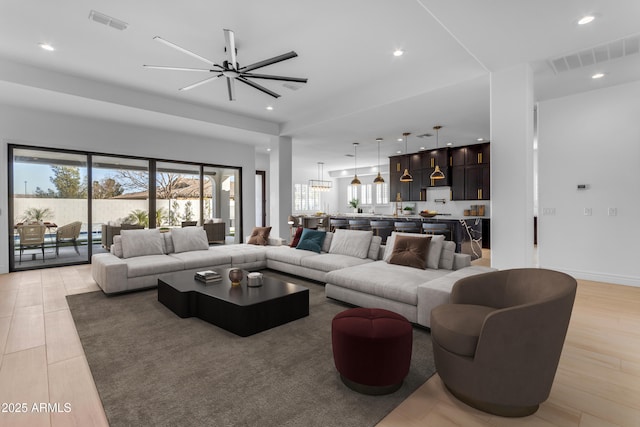 living area with plenty of natural light, visible vents, and recessed lighting