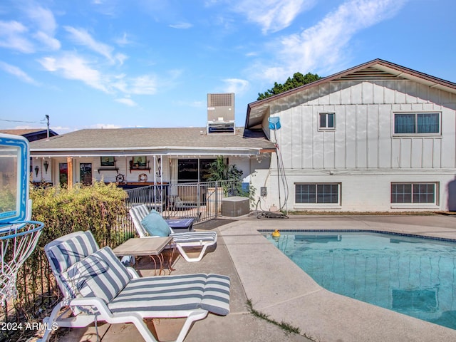 view of swimming pool with a patio and cooling unit