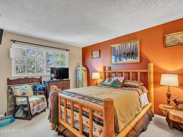 bedroom featuring carpet flooring and a textured ceiling