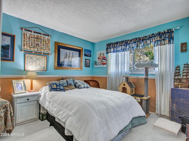 bedroom featuring a textured ceiling and light colored carpet